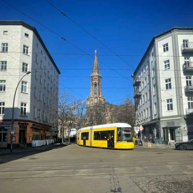 Tram 12 passing in front of Zionskirche, Berlin